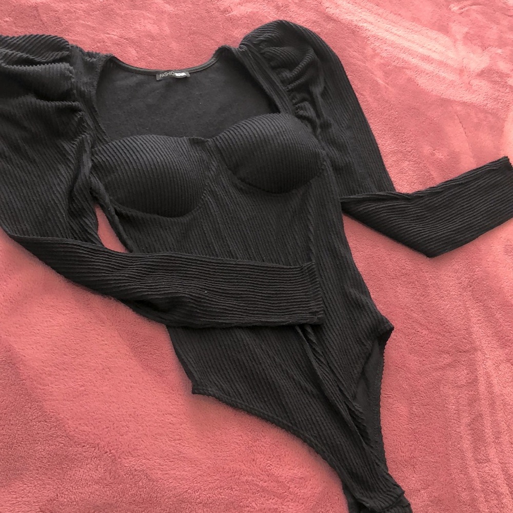 Black, ribbed, puffy sleeve sweater bodysuit.